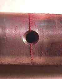 Magnetic particle testing makes cracks more visible.