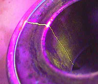 A crack on the inside of a bearing my not have been detected with the naked eye. Fluorescent particle inspection clearly shows the indication.