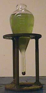A pear shaped centrifuge is used to check the concentration of particles in the suspension.