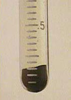 Particle dragout accumulates at the bottom of the pear shaped container.