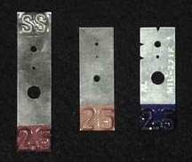Hole-type IQIs look like strips of metal with holes and notches in them.