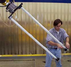 An inspector prepares an ultrasonic squirter to use for an inspection.